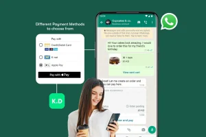 A woman holds a phone and coffee cup while viewing a payment method menu on a WhatsApp chat for a bakery order. Payment options include credit/debit card, K-Net, and Apple Pay.